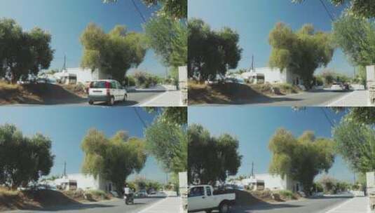 小镇街道上过往的汽车高清在线视频素材下载