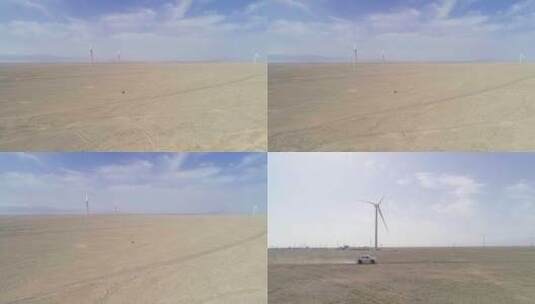 航拍行驶在戈壁滩风力发电基地的汽车高清在线视频素材下载