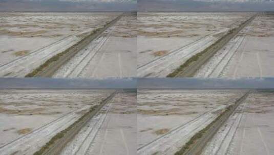 公路穿过新疆塔里木盆地荒芜的盐碱地高清在线视频素材下载