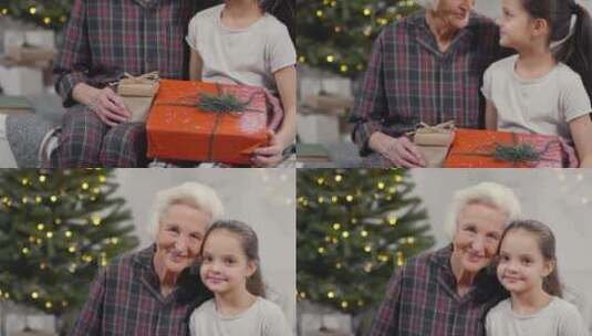 圣诞节祖母抱着孙女拿着礼物高清在线视频素材下载