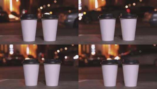 模糊城市灯光背景下的一次性纸杯和热咖啡高清在线视频素材下载