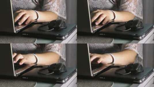 一名妇女在办公桌前使用笔记本电脑_中景高清在线视频素材下载