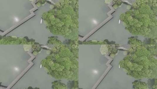 航拍杭州江南小船摇橹船在湖面树林间航行高清在线视频素材下载