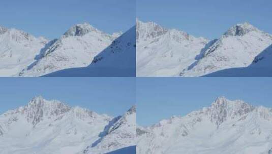 白雪皑皑的山峰和山脊，明亮阳光明媚的冬日，阿尔卑斯山的蓝天高清在线视频素材下载