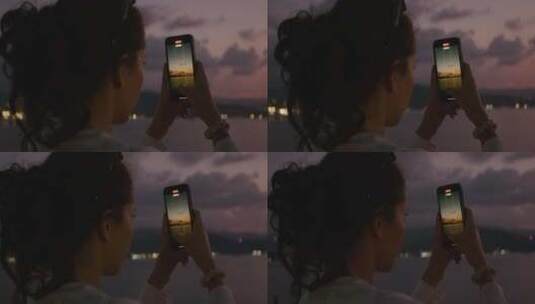 女孩拿起手机拍摄夕阳高清在线视频素材下载