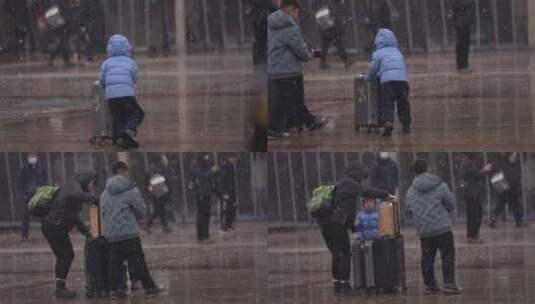 大雪中兴奋地推行李箱的小孩高清在线视频素材下载