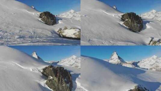 航拍落满雪花的山峰和化雪的岩石高清在线视频素材下载