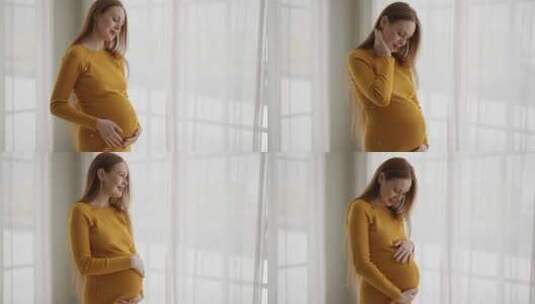 穿着橙色连衣裙的快乐孕妇期待婴儿美丽多情高清在线视频素材下载