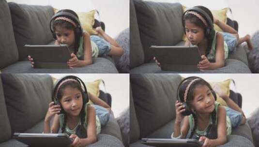 戴耳机的辫子女孩使用平板电脑高清在线视频素材下载