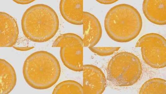 俯拍水泼向白背景上的橙子切片 慢镜头合集高清在线视频素材下载