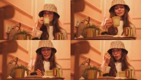 优雅的女人在咖啡馆喝拿铁和吃甜点高清在线视频素材下载