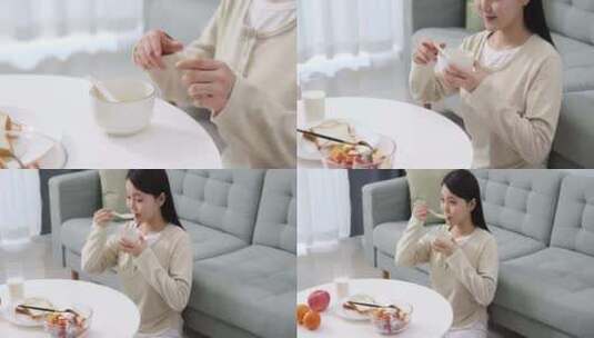 一位年轻女士在家吃早餐高清在线视频素材下载