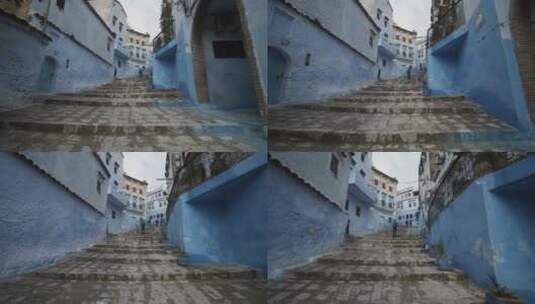 走上一条被漆成蓝色的古老胡同的台阶高清在线视频素材下载