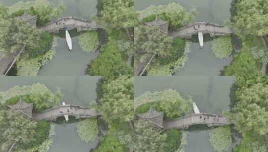 航拍杭州江南小船摇橹船在湖面树林间航行高清在线视频素材下载
