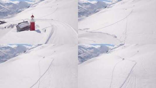 空中拍摄的人行走的雪山高清在线视频素材下载