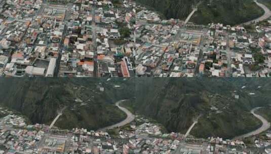 一架无人驾驶飞机在厄瓜多尔苏特巴诺斯市附近蜿蜒的河流旁的城市上空倾斜拍摄高清在线视频素材下载