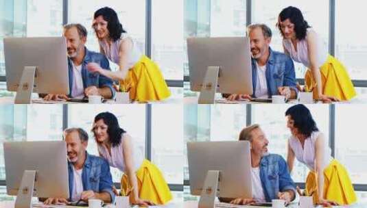 男性和女性平面设计师一起在办公桌前工作高清在线视频素材下载
