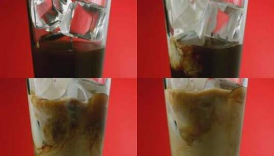 奶油掉进杯子里，红色背景是冰和咖啡高清在线视频素材下载