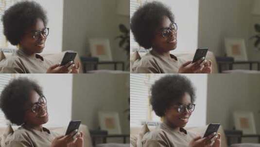 非洲女人看着手机微笑高清在线视频素材下载