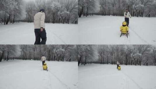 父亲用雪橇拉女儿在雪地里行走高清在线视频素材下载