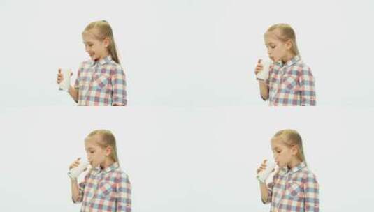 女孩喝牛奶对镜头微笑高清在线视频素材下载