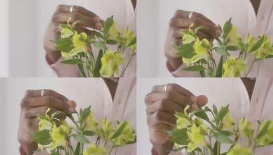 男人摆弄黄色花朵的特写镜头高清在线视频素材下载