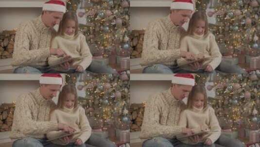 圣诞节父亲陪女儿玩平板高清在线视频素材下载