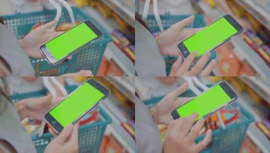 女人在超市使用绿屏手机查询商品价格高清在线视频素材下载