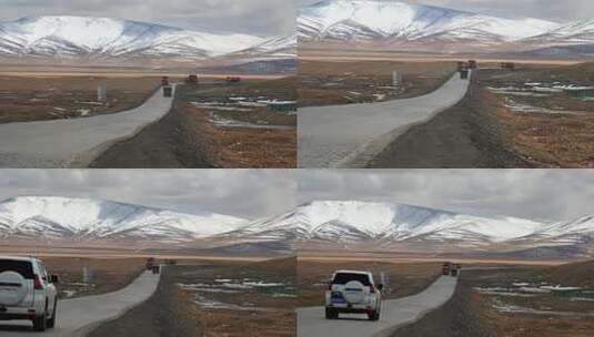 青藏高原青藏公路通过昆仑山口的货运卡车高清在线视频素材下载