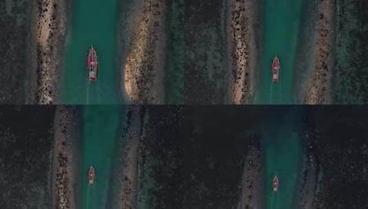 空中飞行跟随上面的渔船从珊瑚礁中的码头出发高清在线视频素材下载