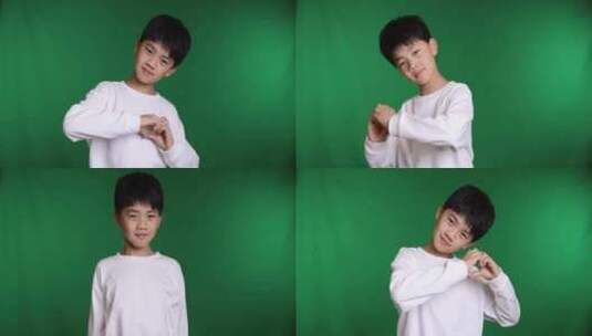 帅气的中国小男孩做手势比爱心8K实拍高清在线视频素材下载