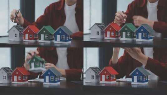 手持钢笔指向彩色房屋模型高清在线视频素材下载