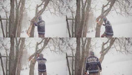 冬天暴风雪中，一个人用电锯切割树干。-广高清在线视频素材下载