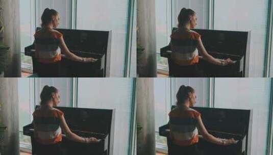 靠近窗户弹钢琴的女人高清在线视频素材下载