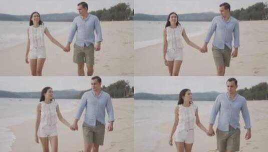 夫妇手牵手在海滩上漫步高清在线视频素材下载