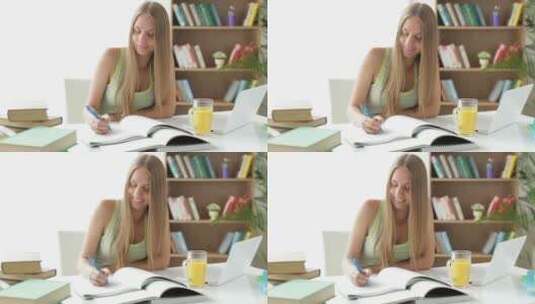 女孩在桌上写练习册高清在线视频素材下载