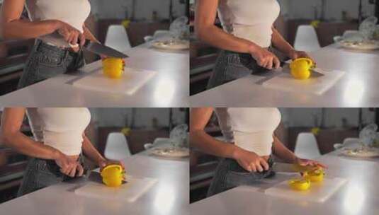 女人在厨房切黄胡椒高清在线视频素材下载
