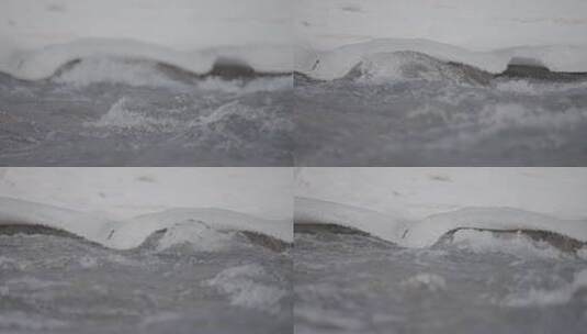 湍急流水冲刷冰雪河岸升格变焦4k100帧灰片高清在线视频素材下载