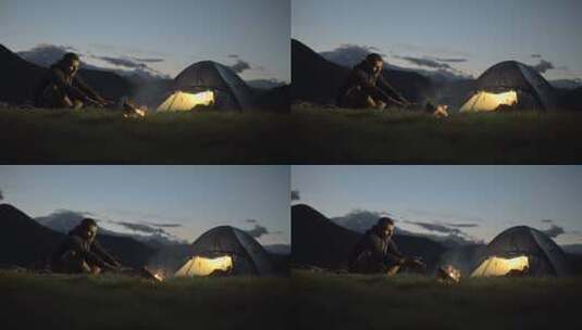 年轻人取暖与营火在自然山户外露营现场在夜间多莉高清在线视频素材下载