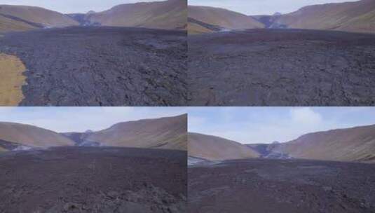 冰岛雷克雅未克法格拉达尔斯法哈尔火山白天喷发后的黑色熔岩场。-空中高清在线视频素材下载