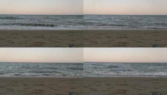 海浪拍打着满是脚印的海岸高清在线视频素材下载