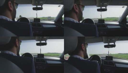 车后座拍摄驾驶汽车的男子高清在线视频素材下载