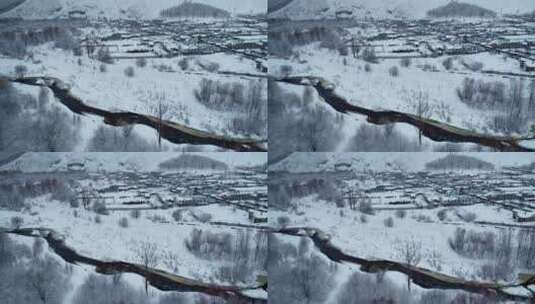 航拍春天大雪后的林区雪村人家高清在线视频素材下载