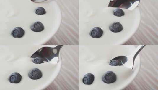 蓝莓酸奶。在希腊酸奶中加入新鲜蓝莓。高清在线视频素材下载