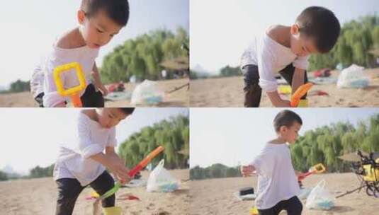 小男孩在河边的沙滩上挖沙子堆城堡高清在线视频素材下载