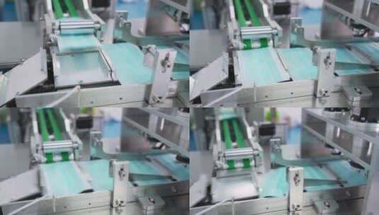 工厂机器正在争相生产口罩医用三层蓝色高清在线视频素材下载