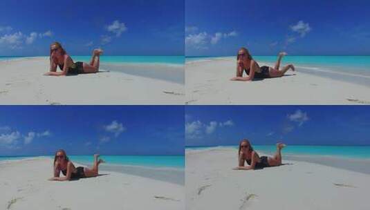 年轻的美女模特在度假，享受夏日白沙和蓝色背景下的海滩生活4K高清在线视频素材下载