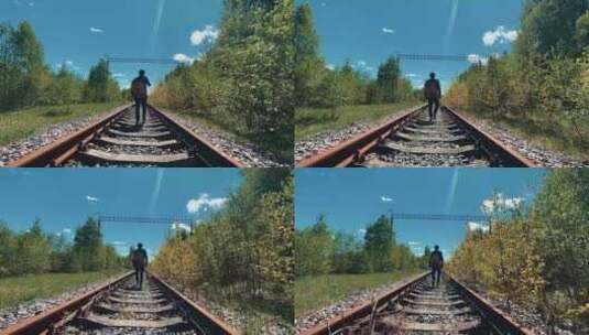 男人背着吉他在铁轨上行走的背影高清在线视频素材下载