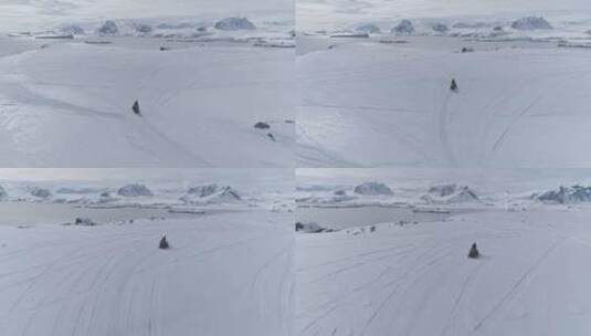 空中飞行在移动的雪地车上。南极洲高清在线视频素材下载