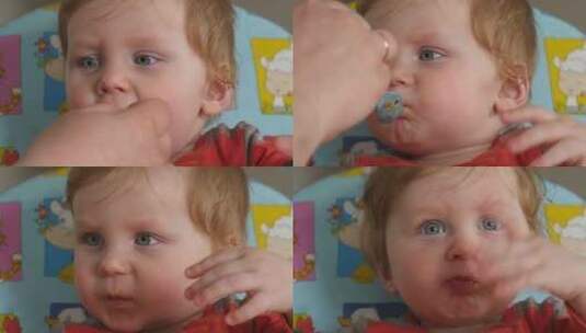 男婴坐在高脚椅上挥手吃着一勺食物高清在线视频素材下载